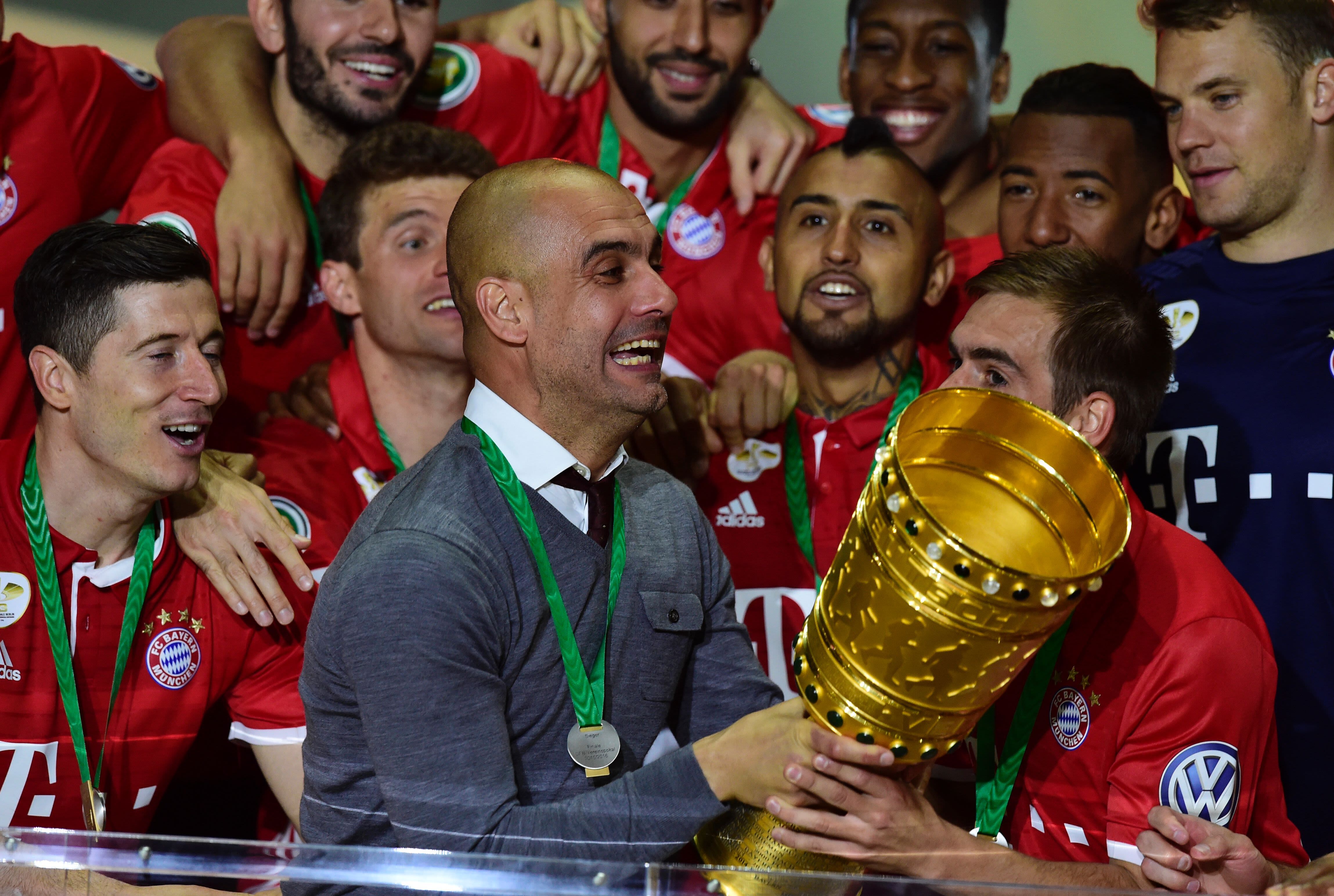 Pep Guardiola jubilantly celebrates Bayern Munich's victory in the DFB Pokal final.